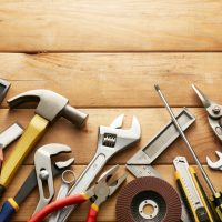 variety of tools on wood planks with copy space
